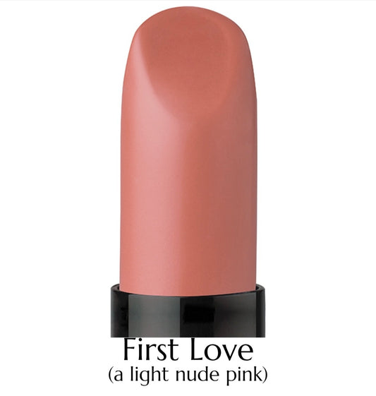 Lipstick with a light nude pink shade labeled 'First Love' on a white background