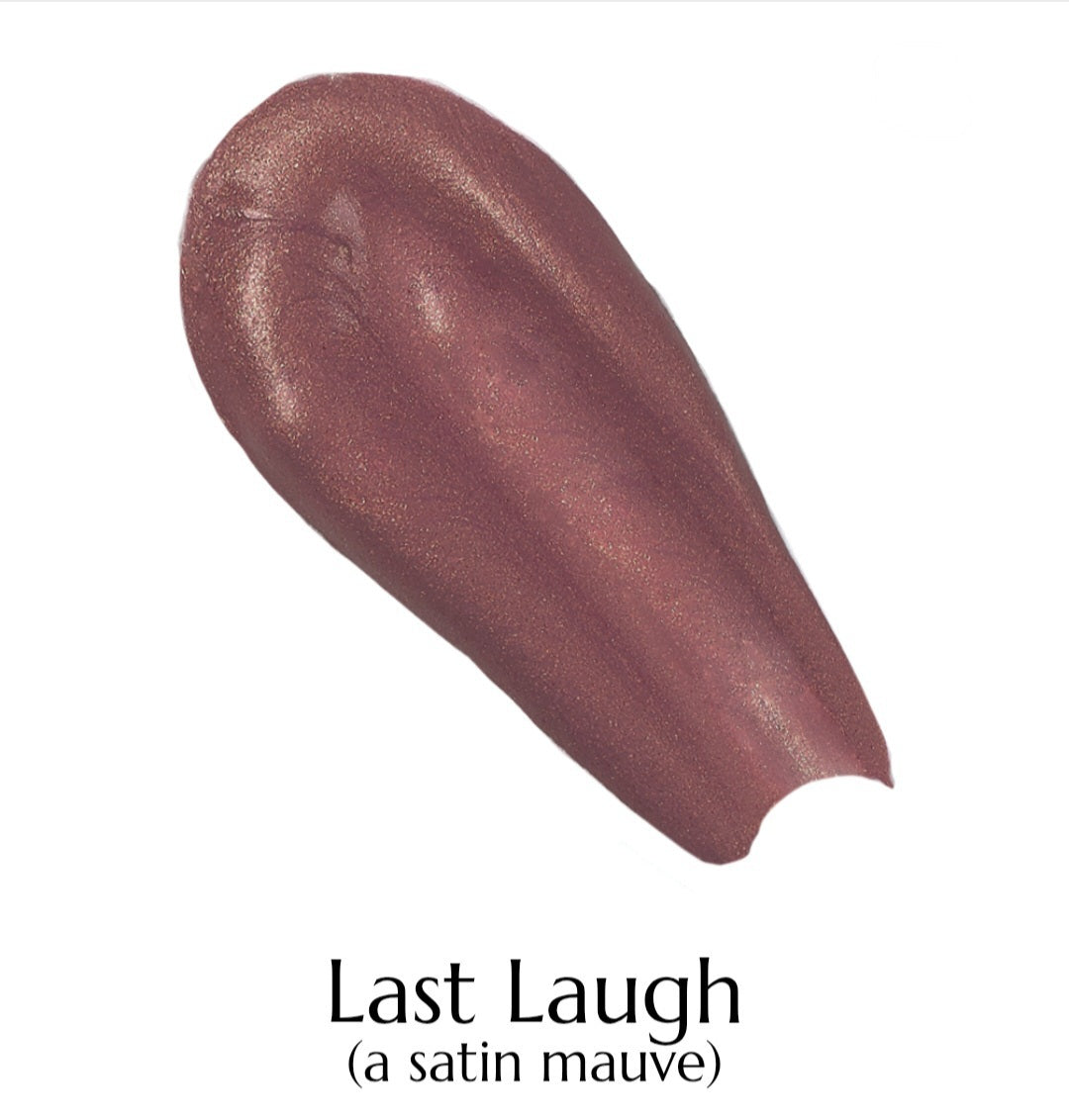 Swatch of a satin mauve lipstick labeled 'Last Laugh' on a white background
