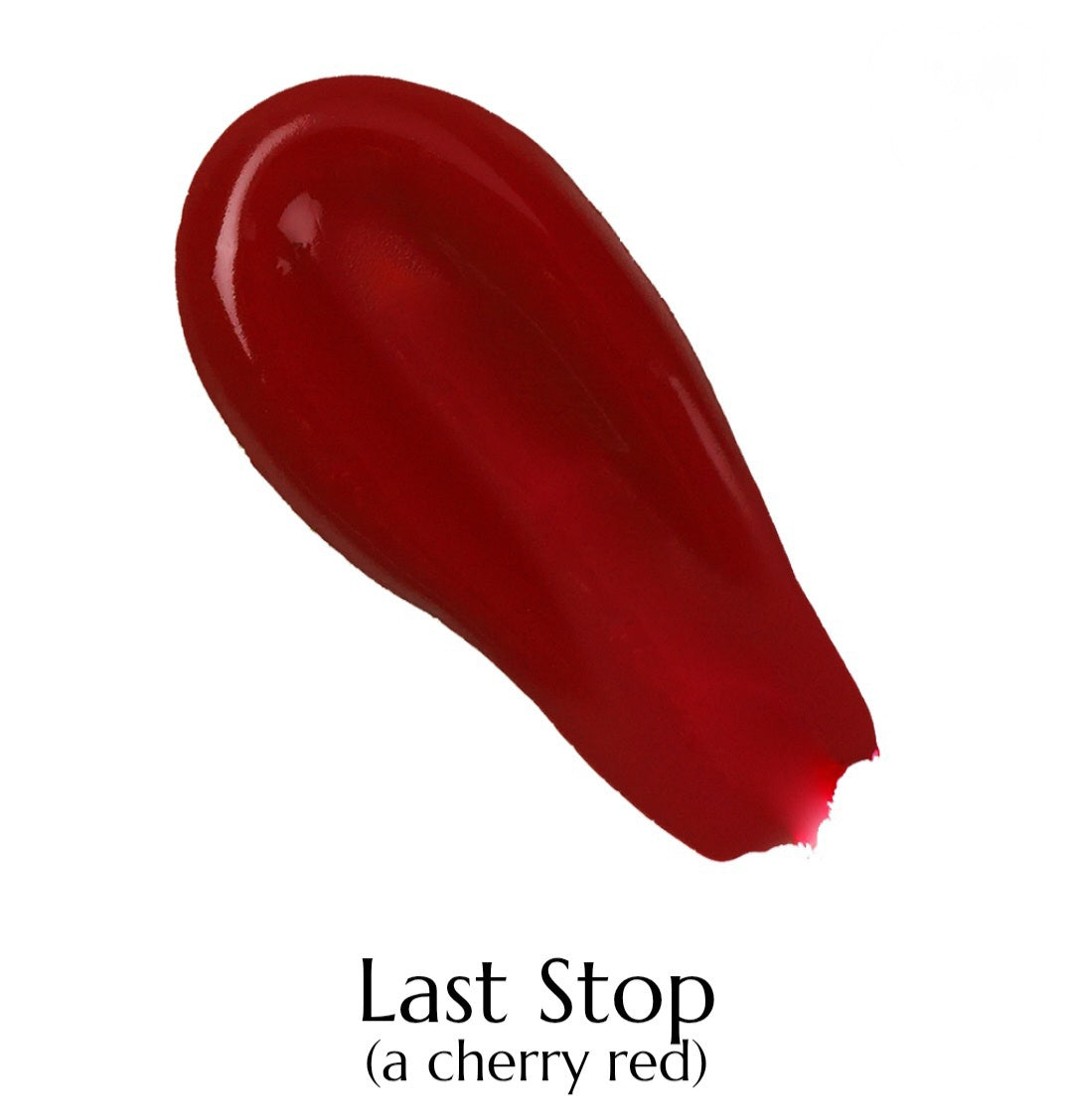 Red lipstick swatch labeled 'Last Stop (a cherry red)' on a white background