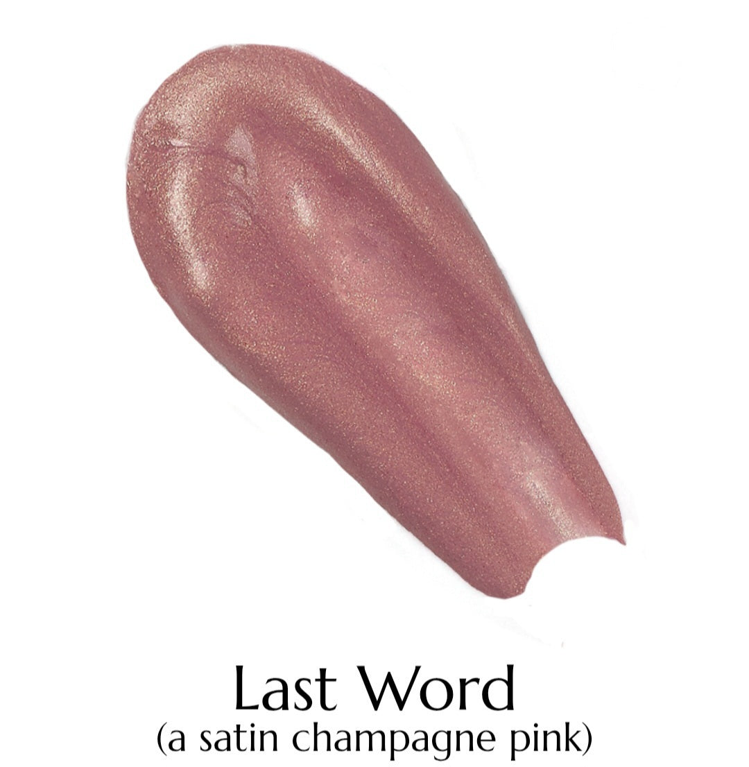Swatch of a satin champagne pink lipstick labeled 'Last Word' on a white background