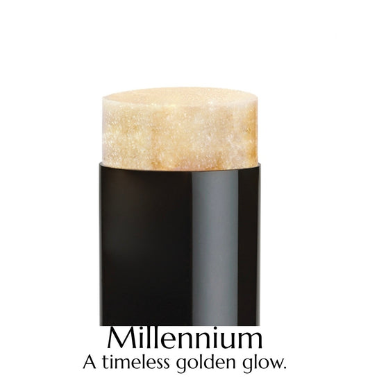 Cosmetic stick with beige top and black body on a white background, labeled 'Millennium'.
